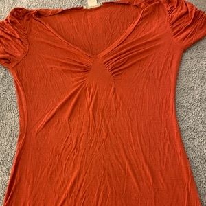 Orange tight fitting shirt